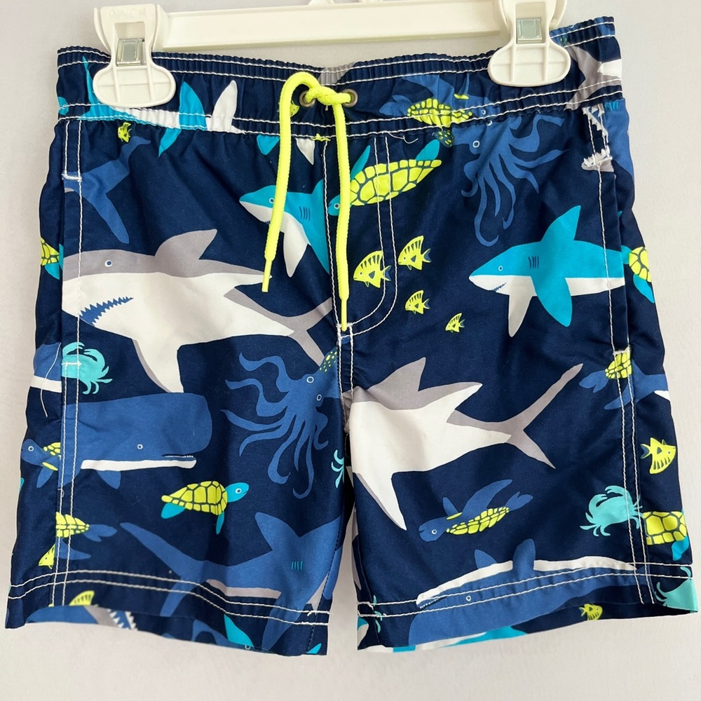 Carters brand shark swim set includes swim trunks and rash guard in blue/yellow!
